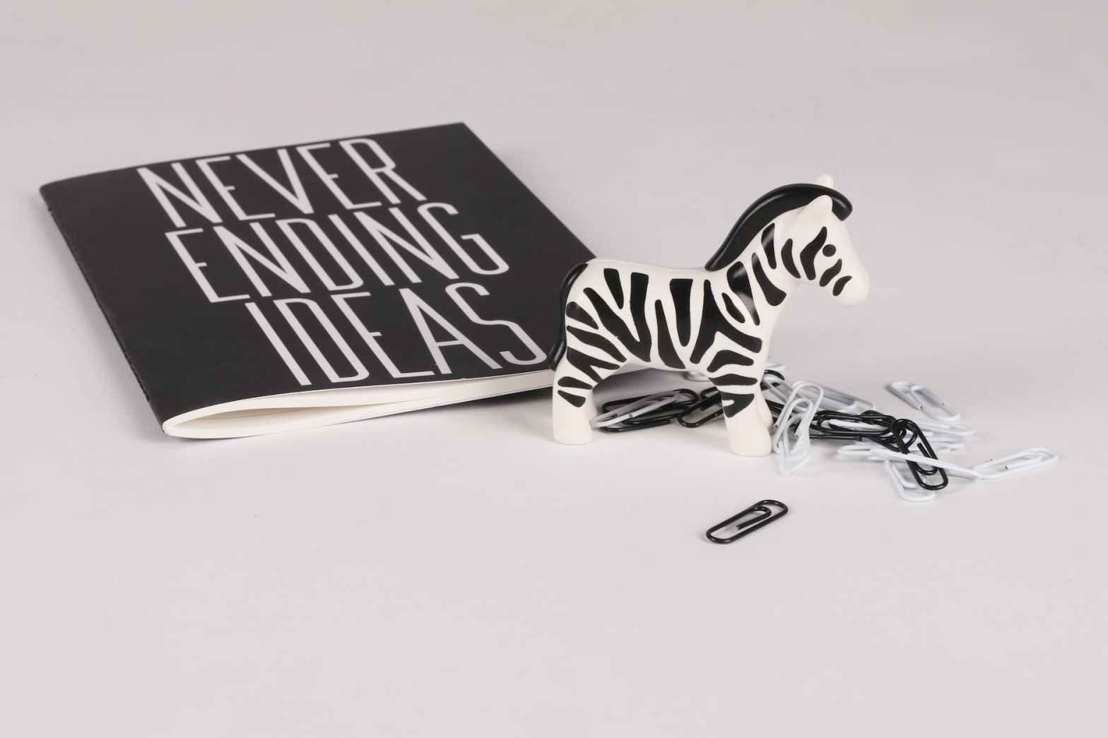 zebra ornament with notebook and paperclips on desk   dr krishna athal