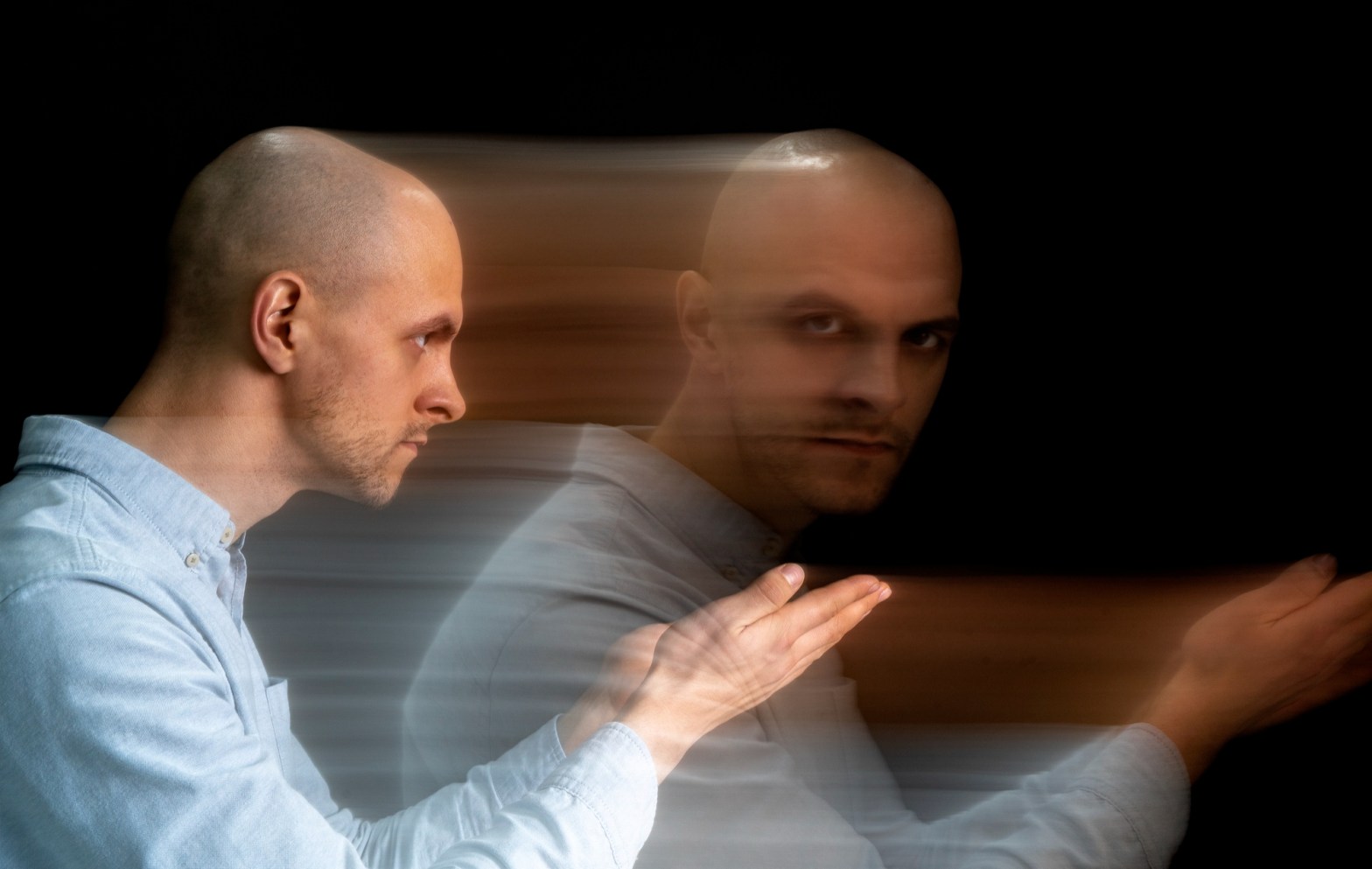 bald man with blurred motion effect against dark background   dr krishna athal