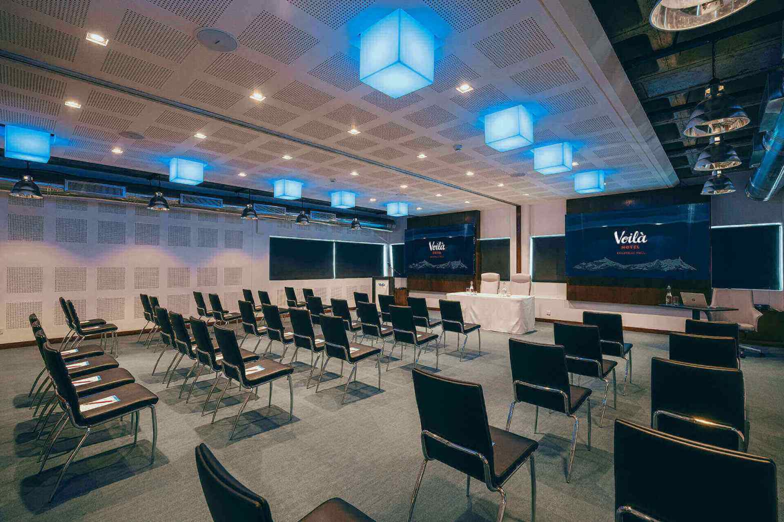 modern conference room with chairs and screens for presentations   dr krishna athal