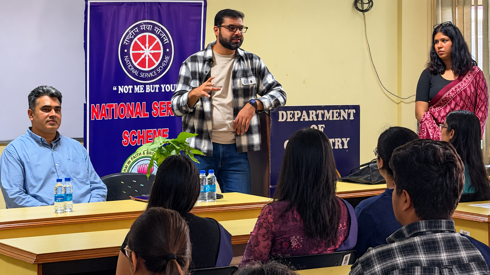 Speaker addresses nss student volunteers at ggdsd college chandigarh in front of a national service scheme banner